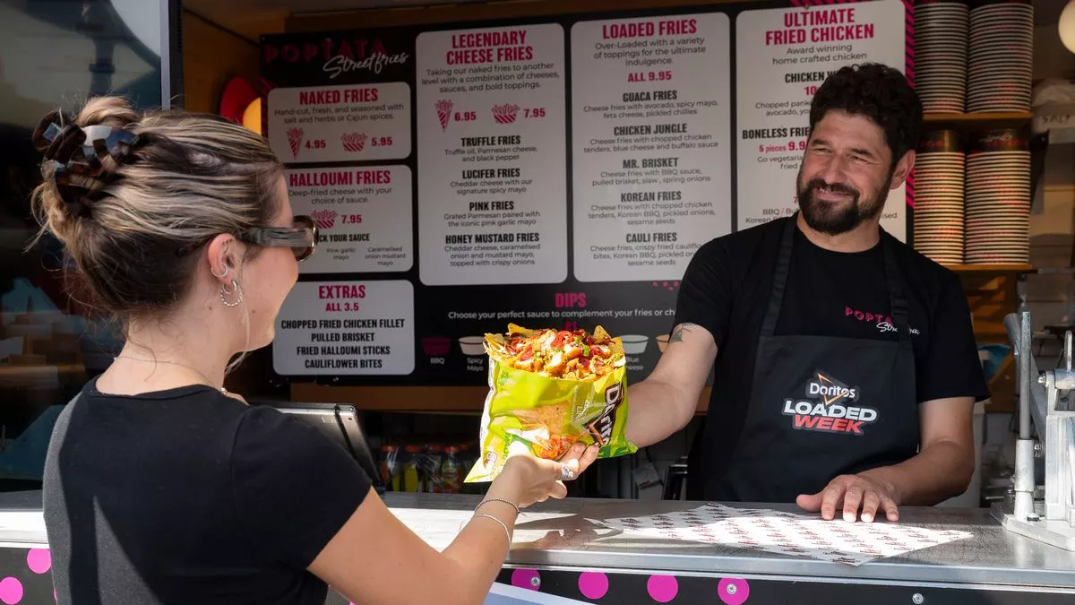 FOTS team running a sampling activation at a street food stand