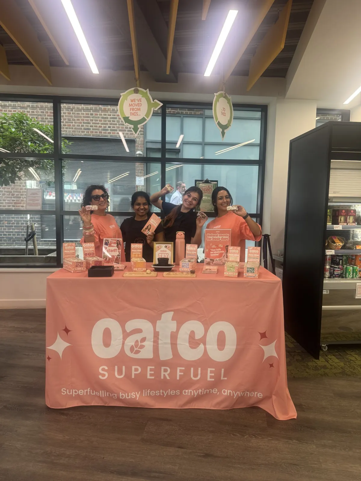 FOTS team sampling Oatco Superfuel Super Bites from a branded stand in a workplace café